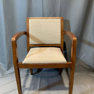 Geiger Guest Chair with wooden frame and beige upholstery.