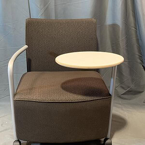 Herman Miller Celeste Chair with attached side table for versatile workspace seating.