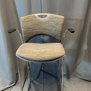 Barstool chair with cushioned seat and backrest, ideal for commercial or home bar settings.