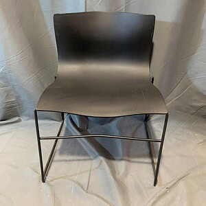 Black patio chair with sleek design for outdoor use.
