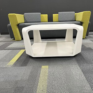 Modern Haworth white cube designer table with yellow and gray seating, ideal for contemporary office.
