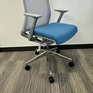 Modern Haworth office chair with chrome base and blue fabric seat.