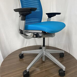 Blue and silver Steelcase Think office chair with adjustable armrests.