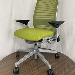 Ergonomic green mesh office chair with adjustable armrests and lumbar support.