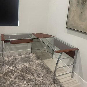 Glass modern 5x5 desk with steel legs for contemporary office setup.