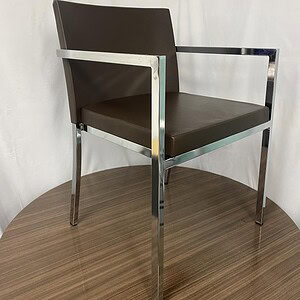 Mocha plush leather chair with chrome frame, modern design, perfect for stylish interiors.