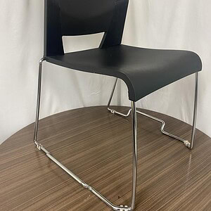 Black Stack Chair with Steel Base for Office or Conference Room.