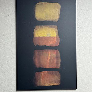Abstract black and warm-toned artwork with bold color blocks.
