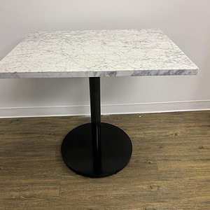 Marble top black base table, 32x24 inches, ideal for modern dining or office spaces. Durable and sty.