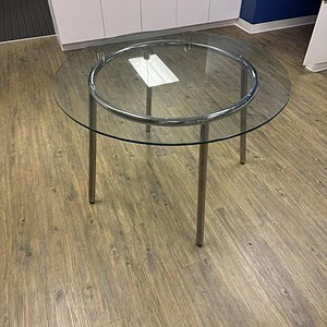 Round glass table with a steel base, 32-inch diameter, ideal for modern office or home settings.