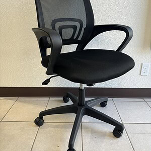 Ergonomic black mesh office chair with tilt lock and adjustable height for comfortable seating.