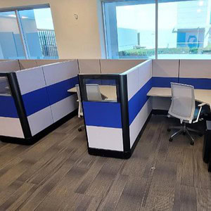 Ethospace cubicle with royal blue, silver, and black accents, featuring a private workspace with a d.