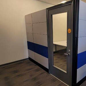 Modern Cube World USA Ethospace office pod with blue accents and glass door.