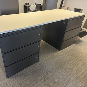 Office desk with three drawers and bar-height top for workspace efficiency.
