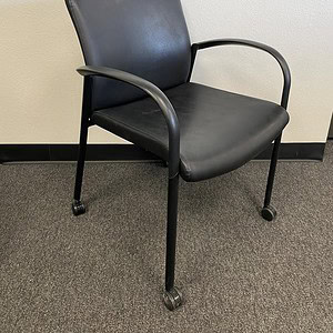 Achieve black office chair with casters, ergonomic design, and armrests for comfortable seating.