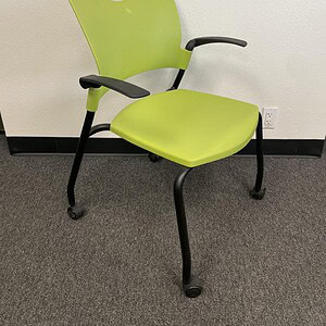 Office chair with green stackable seat and casters for mobility.