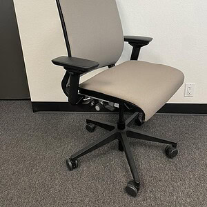 Ergonomic Steelcase Think office chair with tan fabric and black accents.