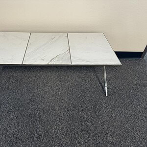 Elegant white marble table with sleek metal legs, perfect for modern interiors.