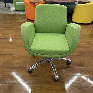 Green office chair with casters and modern design for workspace comfort.