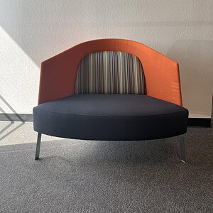 Modern Teknion orange and striped fabric lounge sofa for office or lounge areas.