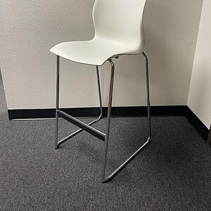 White bar stool with steel base for modern commercial and residential spaces.