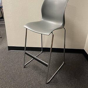 Grey Teknion barstool with steel base, modern design, ideal for commercial or office spaces.