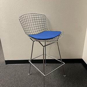 Vitra chrome wire bar stool with blue cushion, modern design for bar or kitchen.