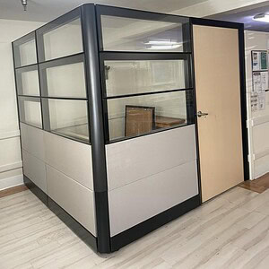 Ethospace office cubicle with glass walls and 42-inch door for modern workspace solutions.