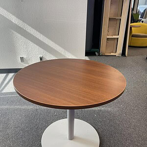 Steelcase round lounge table with medium wood tone finish, ideal for modern office and lounge spaces.