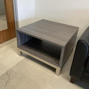 Driftwood coffee table with a built-in storage shelf, perfect for organizing living room essentials.