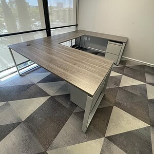 Shape office desk in driftwood finish for professional workspaces.