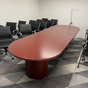 Haworth 12x4 cherry wood conference table in a modern office setting.
