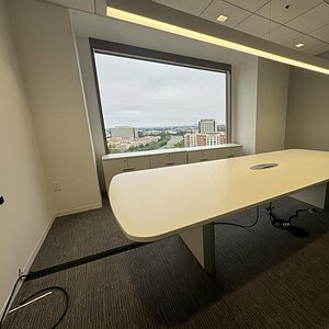 Quality Teknion 11x54 boat-shaped conference table in a modern office setting.