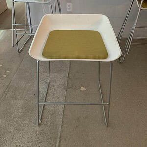 Modern Steelcase Scoop green breakroom stool with white frame and cushioned seat.