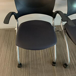 Black nesting chair with ergonomic design, ideal for office and conference room seating.