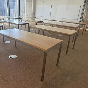 Modern Maple conference table with sturdy metal legs, ideal for corporate meeting rooms.