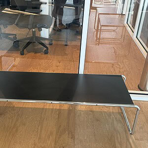 Black rectangular occasional table for modern office or lounge spaces.