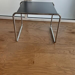 Square black occasional table with sleek metal legs, ideal for contemporary home or office decor.