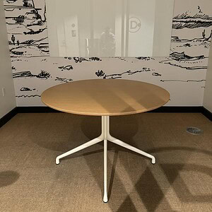 Round meeting table with a natural maple top, ideal for collaborative spaces and conference rooms.