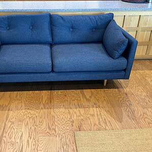 Blue commercial sofa with cushions, ideal for office or lounge areas.