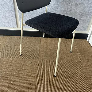 Modern charcoal guest chair with black cushioned seat and backrest, ideal for office or lounge setti.