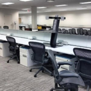 Modern office workspace with Knoll 60x30in powered benching stations and ergonomic chairs.