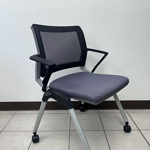 Nesting chair with mesh back and charcoal seat, ideal for office or conference rooms.