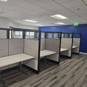 Ethospace glass 5x3 HAT table workstations in modern office.