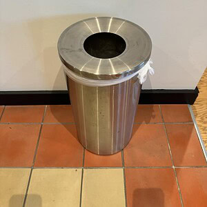Stainless steel trash can with a sleek design, ideal for commercial and residential use.