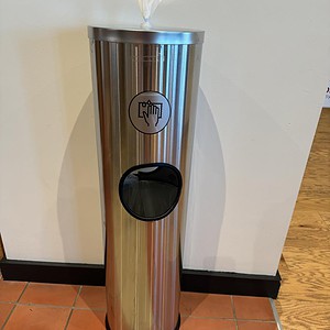 Stainless steel U-Line trash can with foot pedal and touchless lid for hygienic waste disposal.