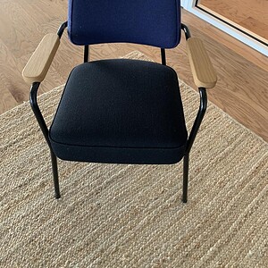 Vitra executive lounge chair with veneer and plush upholstery, ideal for modern office spaces.