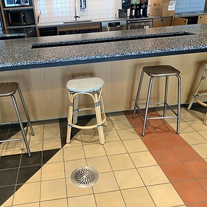 White wicker style stools at kitchen island, modern interior design.