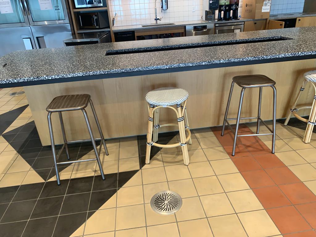 We Work white wicker style stools