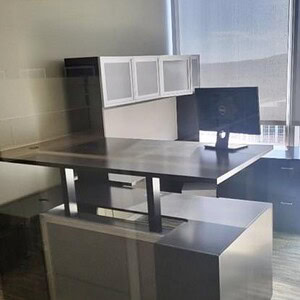 Modern Indiana Driftwood Grey 6x9 height adjustable executive desk in office setting.